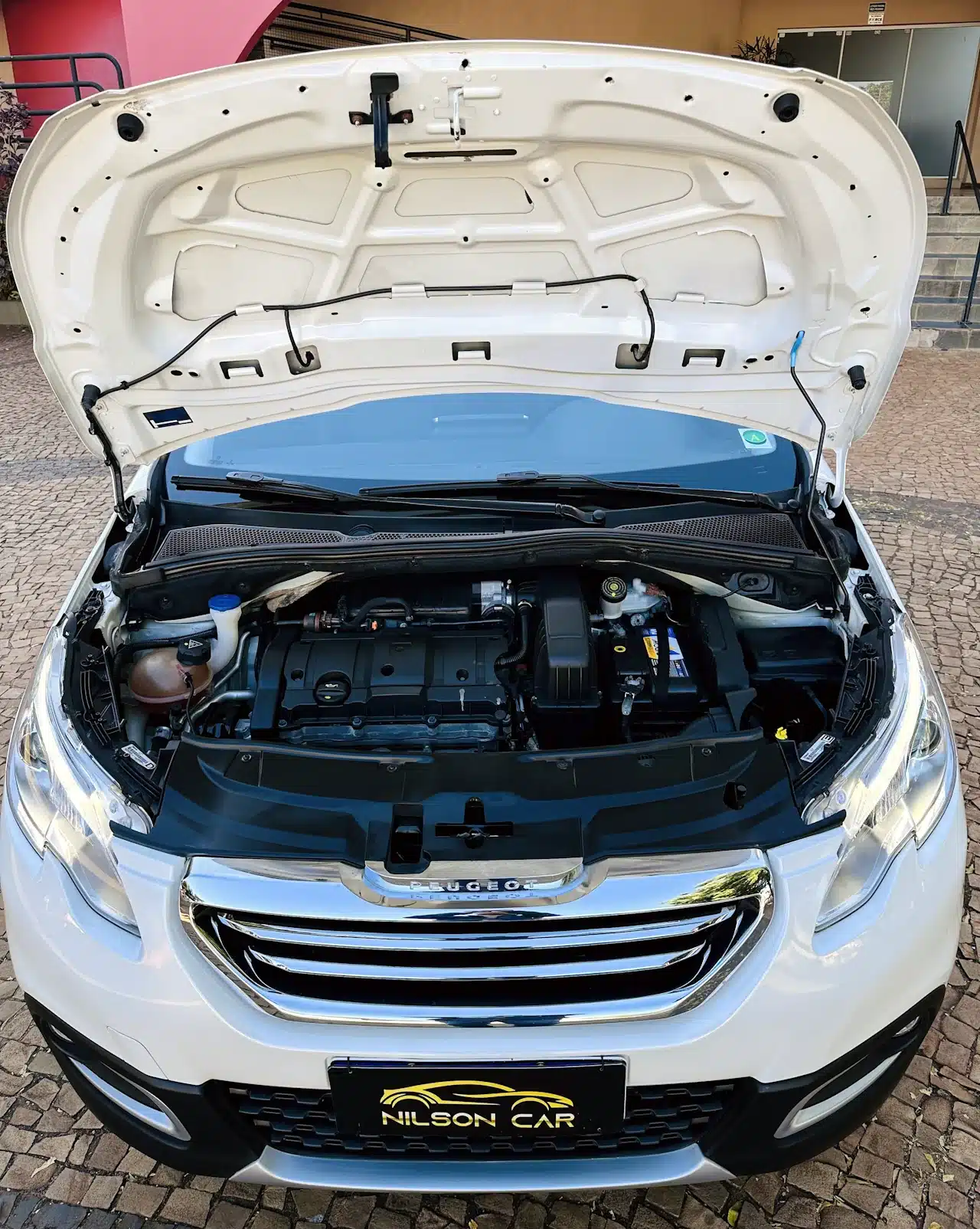 2016 PEUGEOT 2008 16 ALLURE BRANCA - engine - Nilson Car White car with hood raised, exposing the engine bay and components such as the battery, coolant reservoir, and air intake.