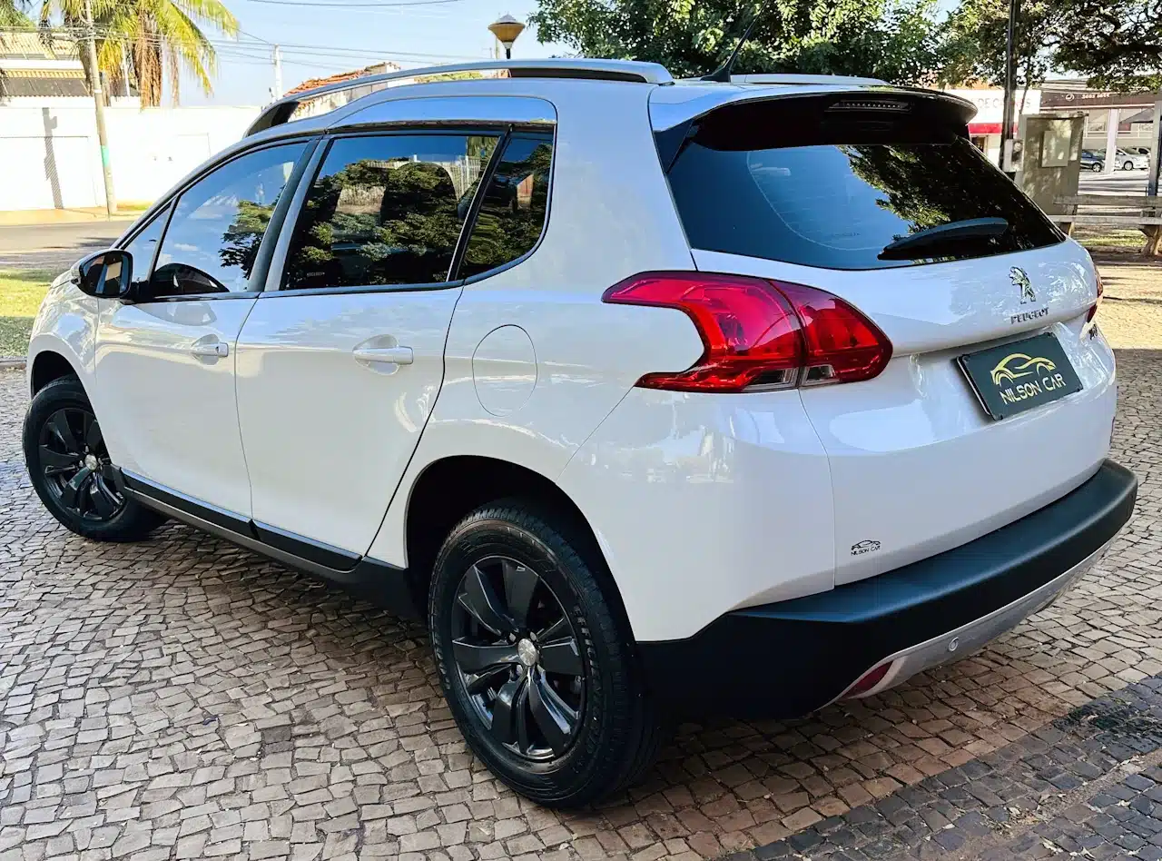 2016 PEUGEOT 2008 16 ALLURE BRANCA - rear_side2 - Nilson Car White Peugeot SUV parked on brick pavement, rear three-quarter view showing black wheels and tinted windows, dealership plate visible.